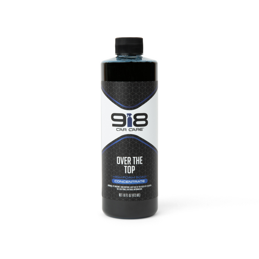 16fl oz black squeeze bottle with white trim of 918 Car Care Over the Top: High Foam Soap Concentrate. Both the subheading, and the spray bottle in the company logo, are blue.